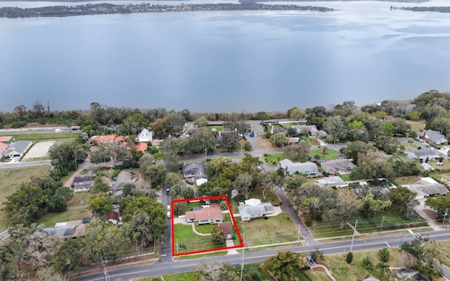 drone / aerial view featuring a residential view and a water view