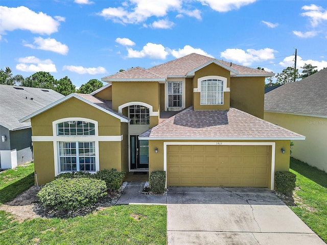 traditional home featuring driveway, an attached garage, roof with shingles, and stucco siding