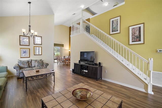 living area featuring high vaulted ceiling, stairway, dark wood finished floors, and a chandelier