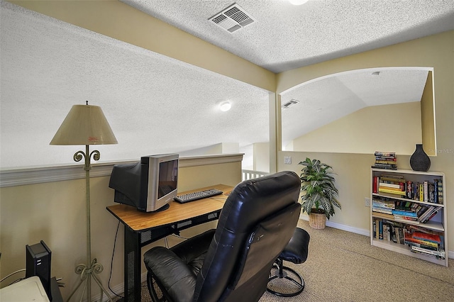 office featuring carpet, visible vents, lofted ceiling, and a textured ceiling