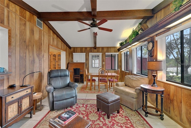 living area featuring vaulted ceiling with beams, light tile patterned floors, wooden walls, and visible vents