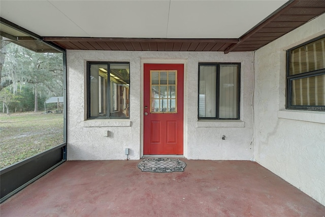 doorway to property with stucco siding