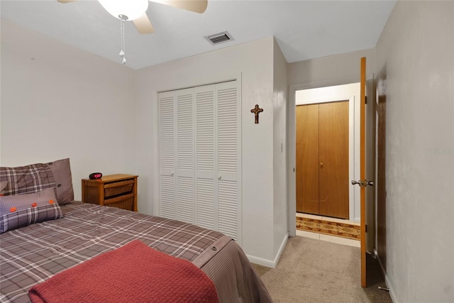 bedroom featuring ceiling fan, visible vents, baseboards, a closet, and carpet