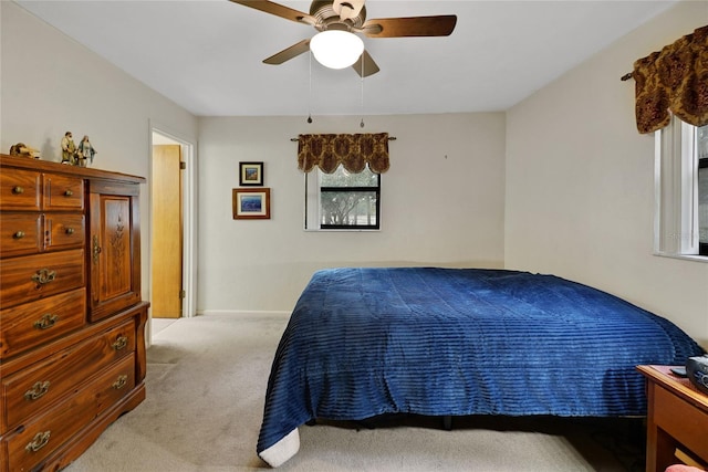 bedroom featuring ceiling fan and light colored carpet