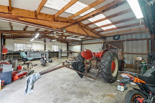 garage featuring metal wall and a workshop area