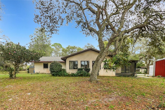 ranch-style house with a front lawn and stucco siding