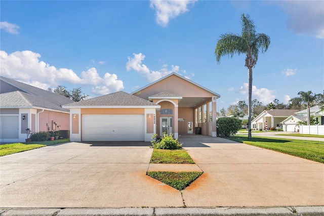 view of front of house with driveway, an attached garage, and stucco siding