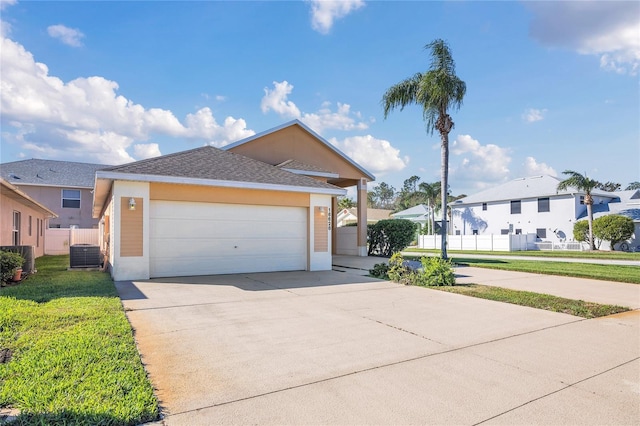 view of front of home featuring fence, concrete driveway, a residential view, stucco siding, and a front yard