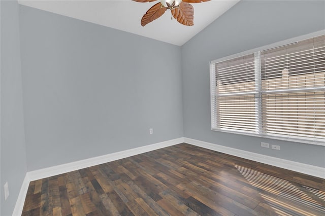 spare room with lofted ceiling, dark wood finished floors, baseboards, and ceiling fan