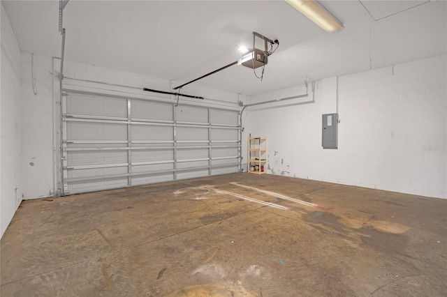 garage featuring a garage door opener, concrete block wall, and electric panel