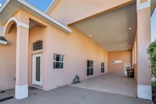 exterior space with a patio area and stucco siding