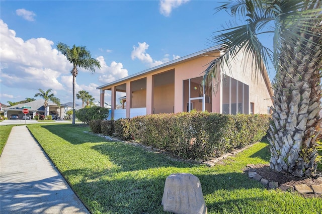 view of property exterior featuring a yard and stucco siding