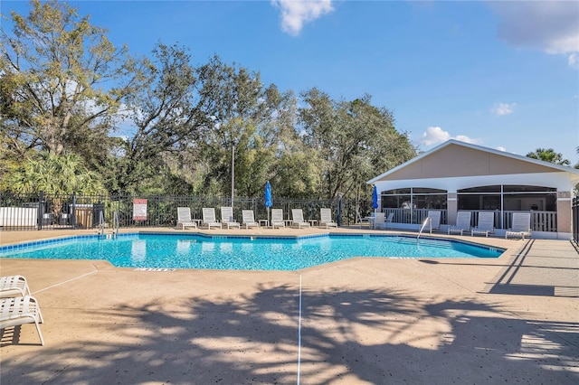 pool with fence and a patio