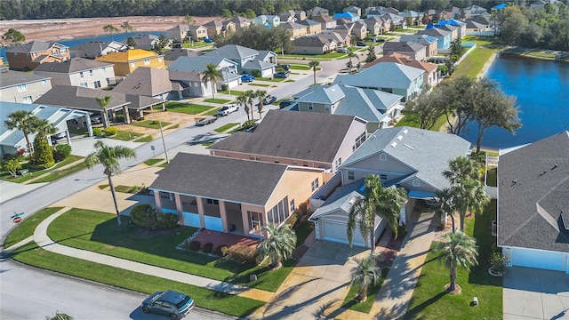 birds eye view of property featuring a water view and a residential view