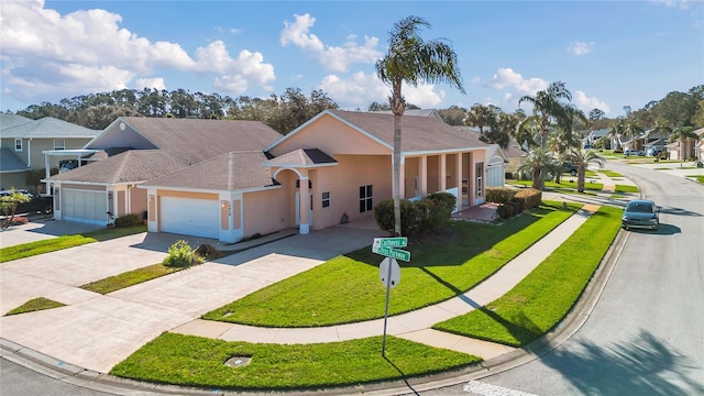 view of front facade with roof with shingles, stucco siding, a garage, a residential view, and driveway