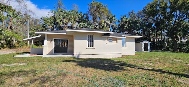 view of front of house with a front lawn and stucco siding