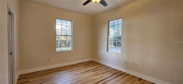 unfurnished room with light wood-style floors, baseboards, and a ceiling fan