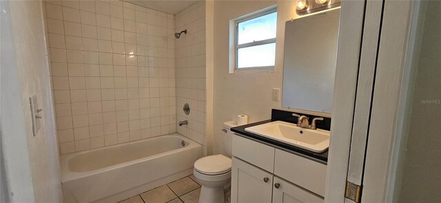 bathroom featuring toilet, vanity, tub / shower combination, and tile patterned floors