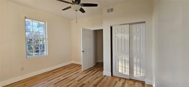 unfurnished bedroom featuring a closet, visible vents, a ceiling fan, light wood-type flooring, and baseboards