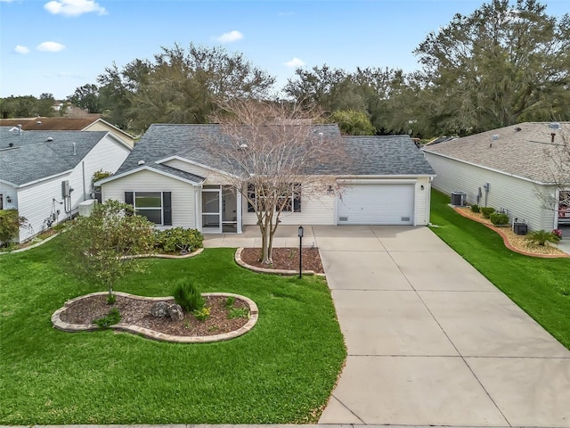 single story home featuring concrete driveway, a front lawn, and roof with shingles