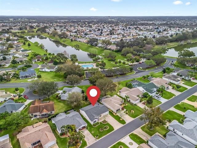 birds eye view of property with a water view and a residential view