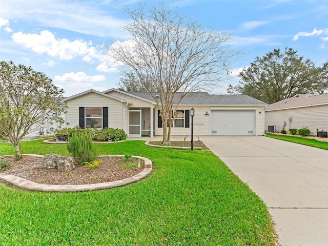 single story home with concrete driveway, an attached garage, a front lawn, and central air condition unit