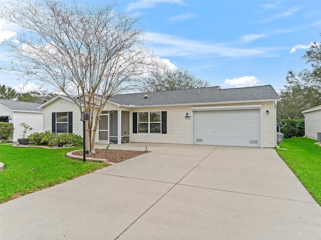 ranch-style house featuring a garage, a front yard, roof with shingles, and driveway