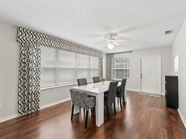 dining room with a ceiling fan, baseboards, visible vents, and dark wood-style flooring