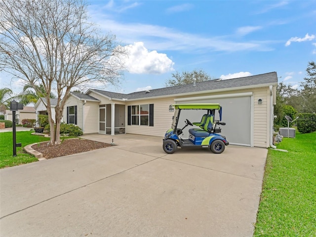 single story home featuring a garage, a front lawn, and concrete driveway