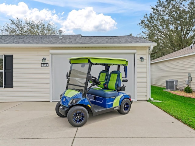 garage with driveway and central AC