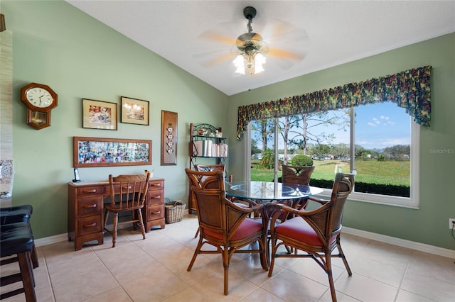 dining area with lofted ceiling, light tile patterned flooring, ceiling fan, and baseboards