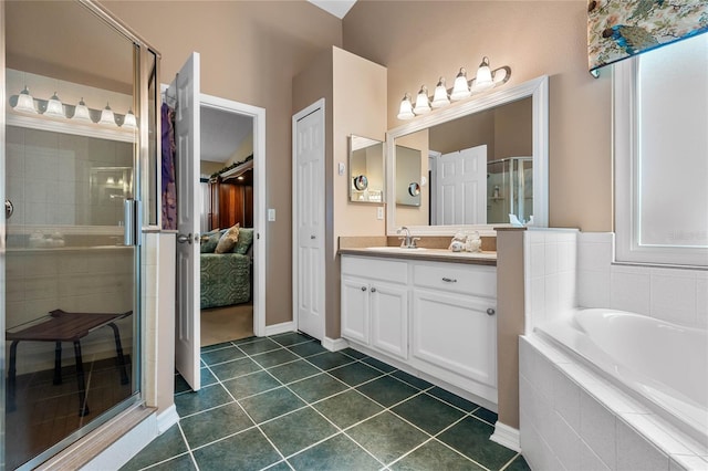 full bath featuring a stall shower, a garden tub, tile patterned flooring, vanity, and a closet