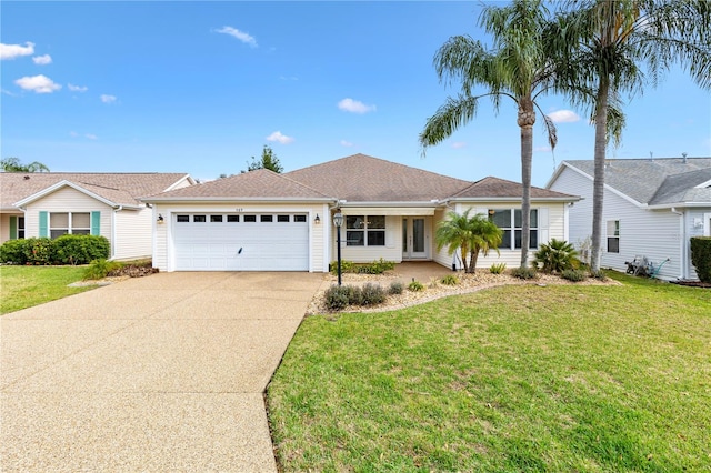 ranch-style home with a garage, a front yard, and driveway