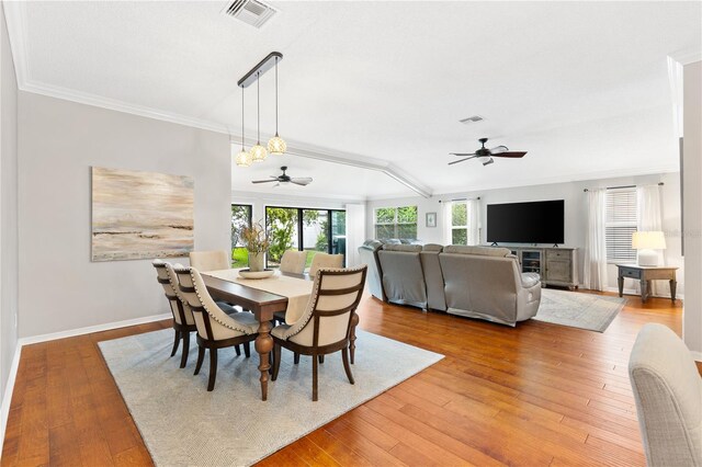 dining room featuring ornamental molding, visible vents, baseboards, and wood finished floors