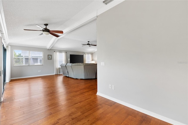 unfurnished living room featuring a ceiling fan, a textured ceiling, baseboards, and wood finished floors