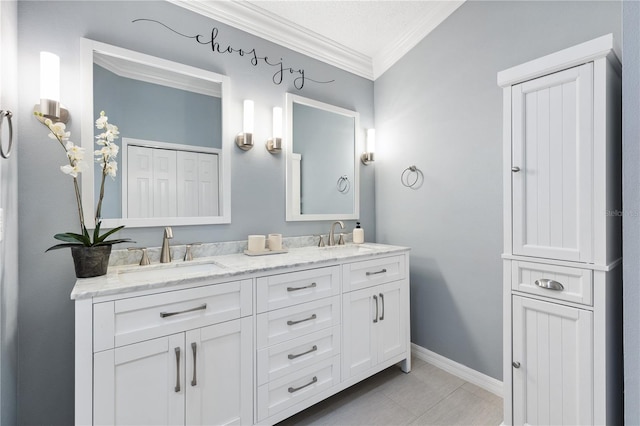 full bathroom with double vanity, a closet, ornamental molding, and a sink