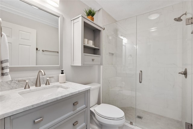 full bathroom with a stall shower, vanity, toilet, and a textured ceiling