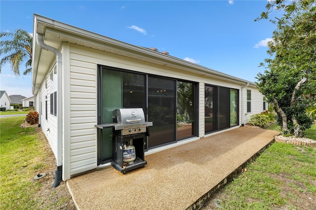 back of property featuring a yard and a patio