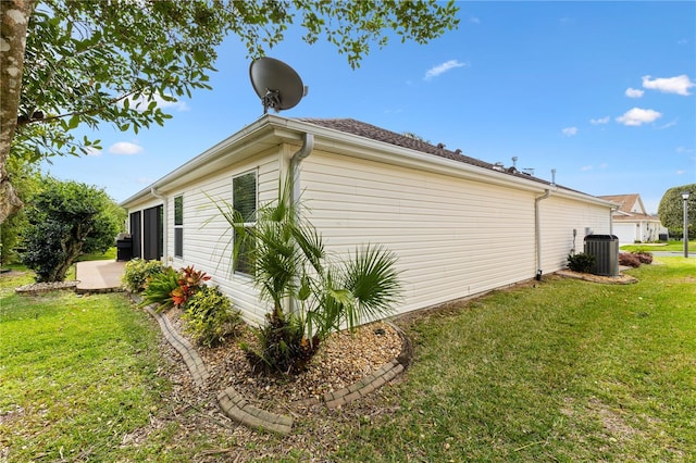 view of home's exterior with central air condition unit, a patio, and a yard