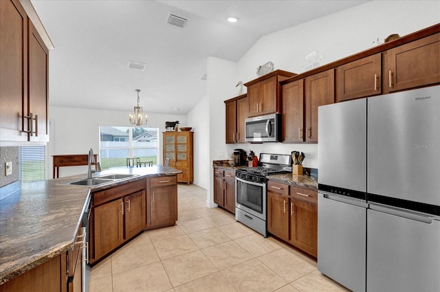 kitchen featuring stainless steel appliances, visible vents, hanging light fixtures, vaulted ceiling, and a sink