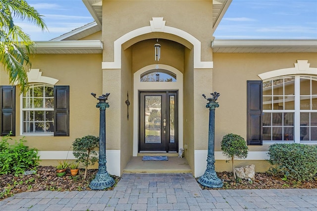 doorway to property with stucco siding