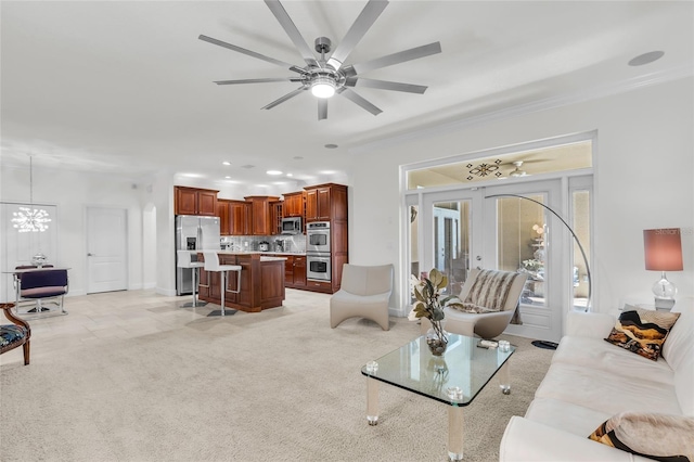 living area featuring recessed lighting, light carpet, ceiling fan with notable chandelier, baseboards, and french doors