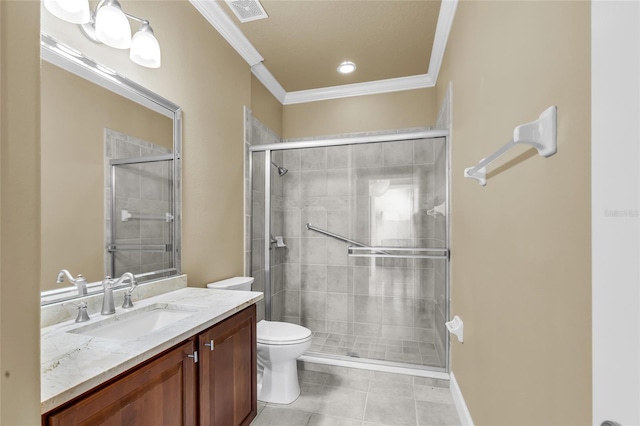 bathroom featuring toilet, vanity, visible vents, a stall shower, and crown molding