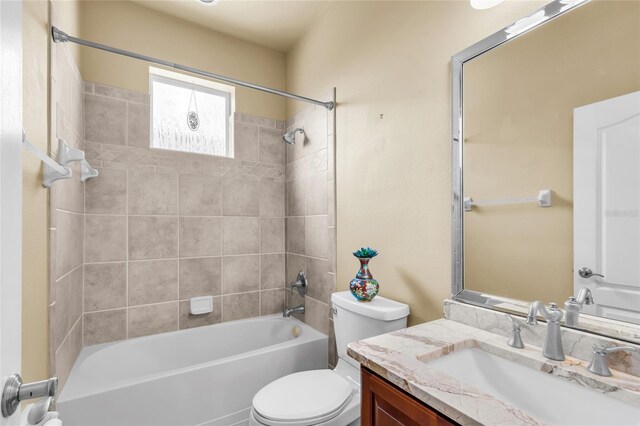 bathroom featuring  shower combination, vanity, and toilet