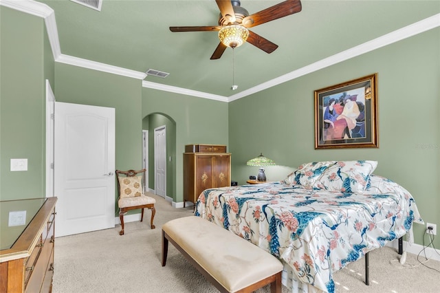 bedroom featuring light carpet, baseboards, visible vents, arched walkways, and crown molding