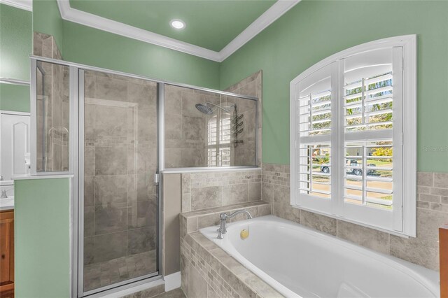 bathroom featuring ornamental molding, a garden tub, vanity, a shower stall, and a wealth of natural light