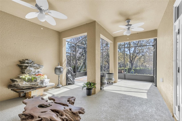 sunroom / solarium featuring a ceiling fan