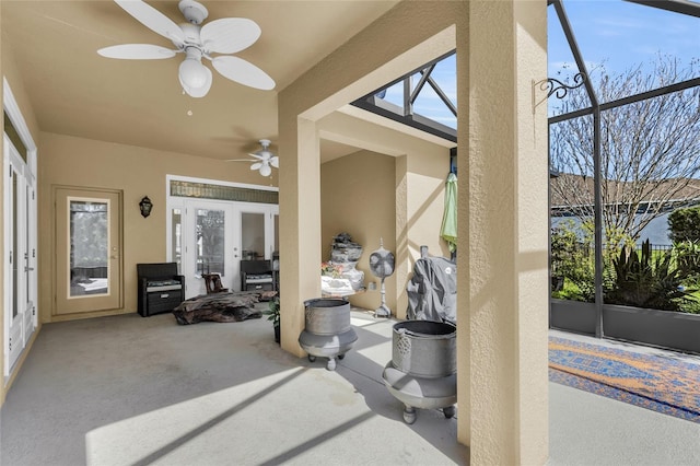 view of patio with french doors, glass enclosure, and ceiling fan