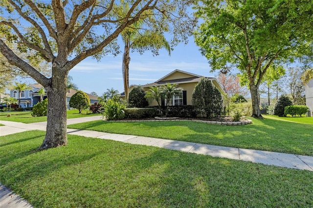 obstructed view of property featuring a front yard and stucco siding