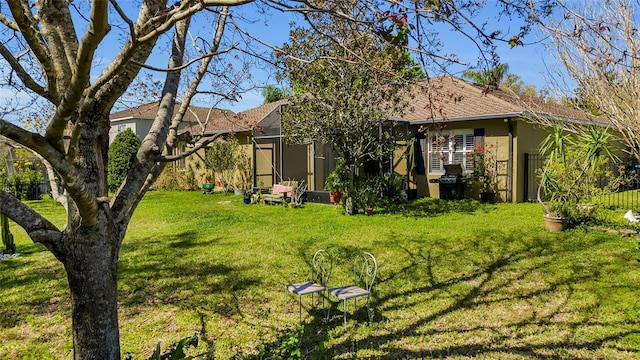 exterior space with a yard, a lanai, and stucco siding